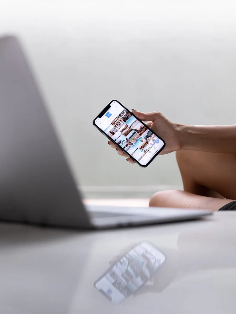 Hand holding a phone showing an Instagram profile feed, the surface where shares and sends push content to non-followers