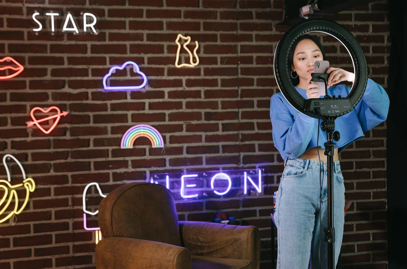 Influencer filming an Instagram Reel with a ring light, creating content to maximize views and reach