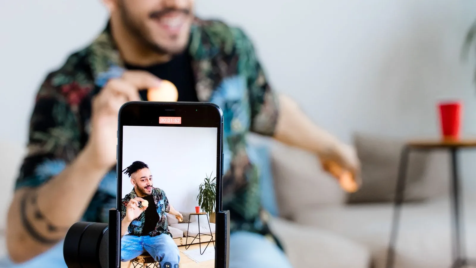 Content creator filming Instagram content on a phone, the kind of creator who buys Instagram likes to boost engagement on posts and reels