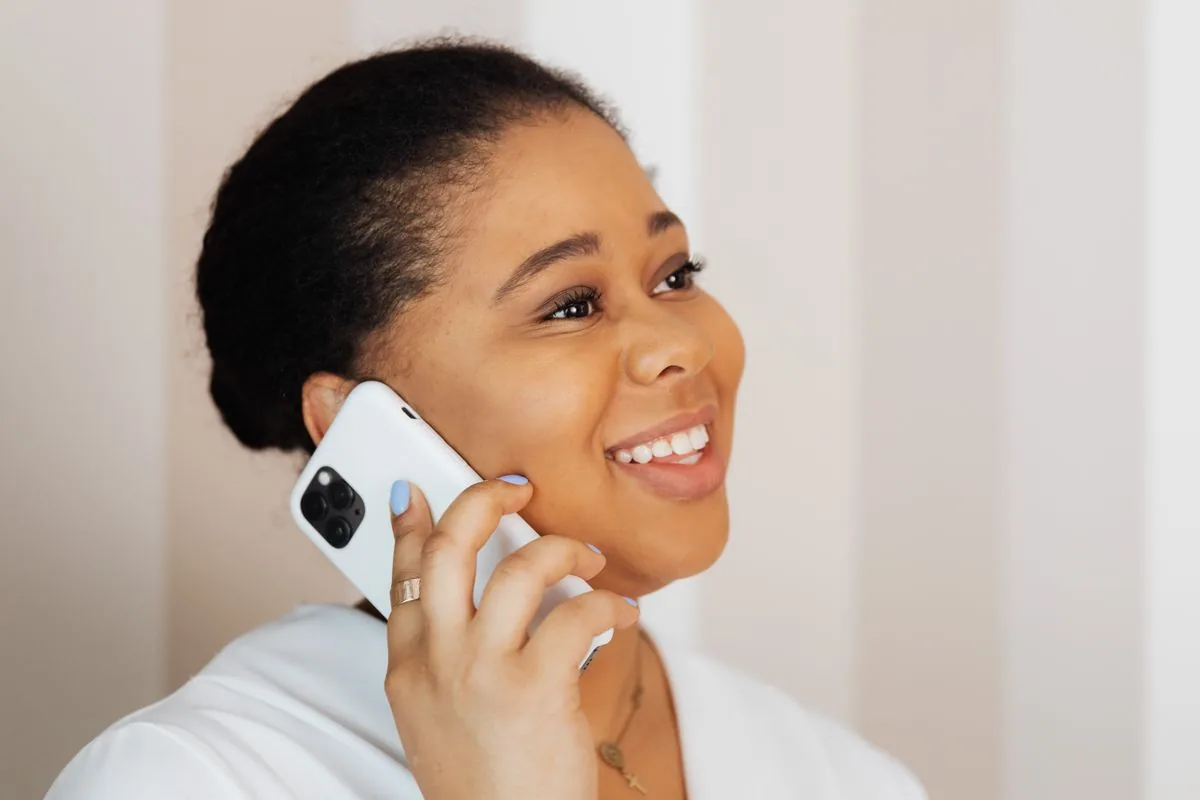 Person calmly holding a phone with both hands, illustrating a safe, password-free way to buy TikTok followers using only a public profile URL