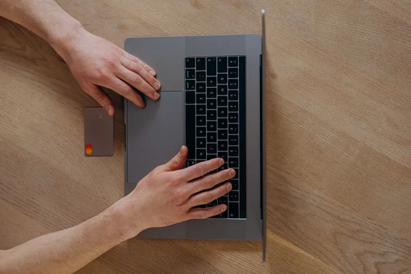 Person buying TikTok likes on a laptop and paying securely, using only the public video URL and no password
