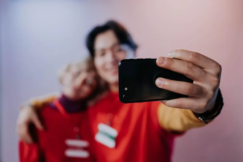 Two friends filming a TikTok together and reacting to it, the kind of genuine moment that earns real likes and the watch time behind them