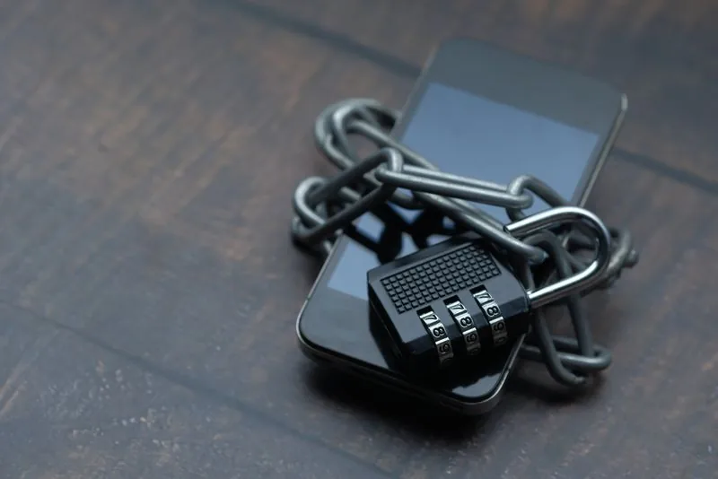 A smartphone wrapped in a chain and padlock, showing that buying likes safely means a password-free order that never puts your account at risk