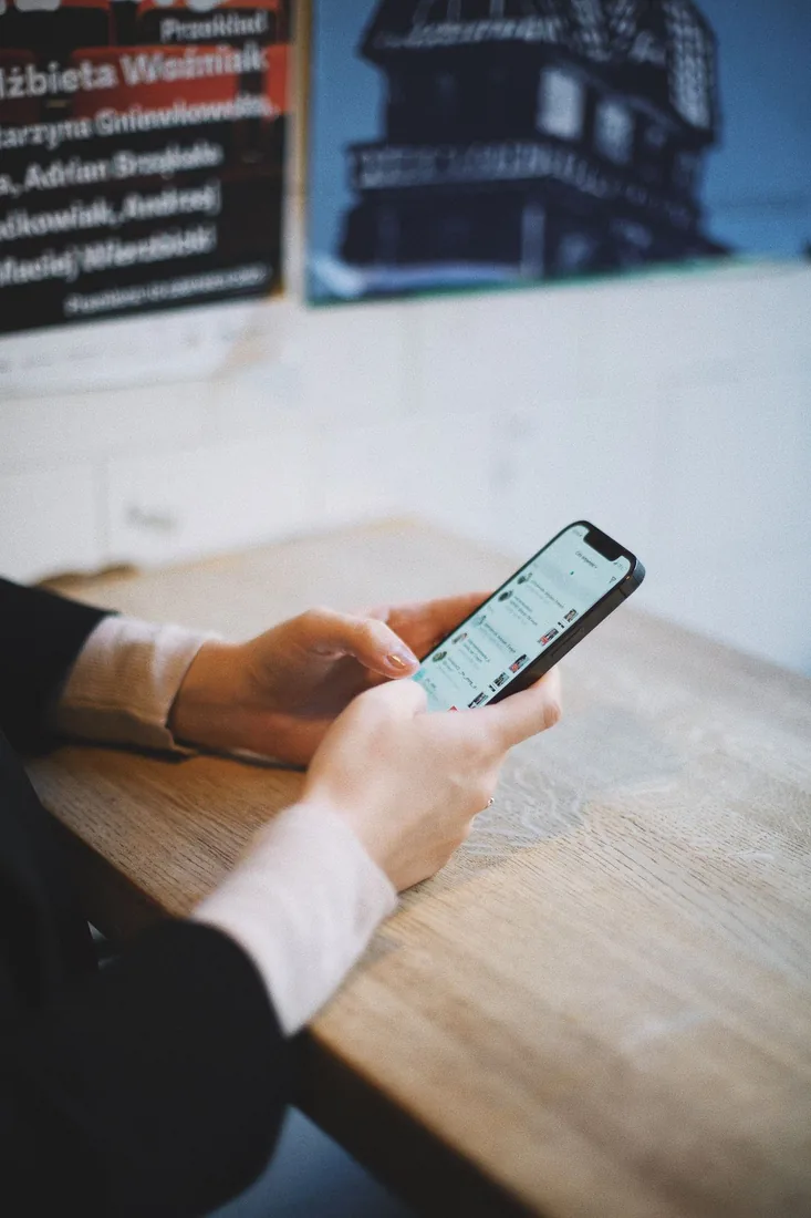 Hands holding a phone and sending a video in a messaging app, the most common kind of TikTok share that carries a video off the platform into a private chat