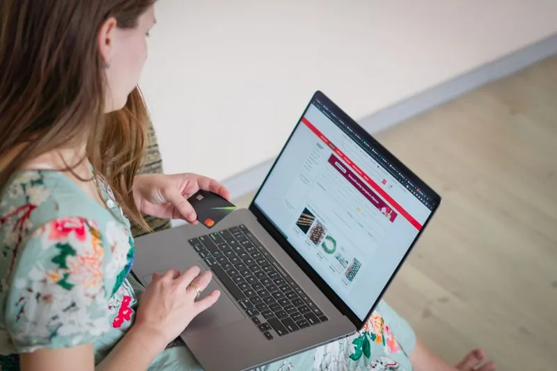 Person choosing a TikTok views package on a laptop and paying securely with a card, using only the public video URL