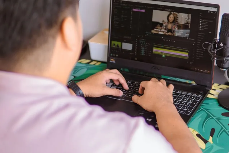 Creator editing a TikTok video on a laptop and checking analytics, tightening the hook and retention so bought views convert into watch time