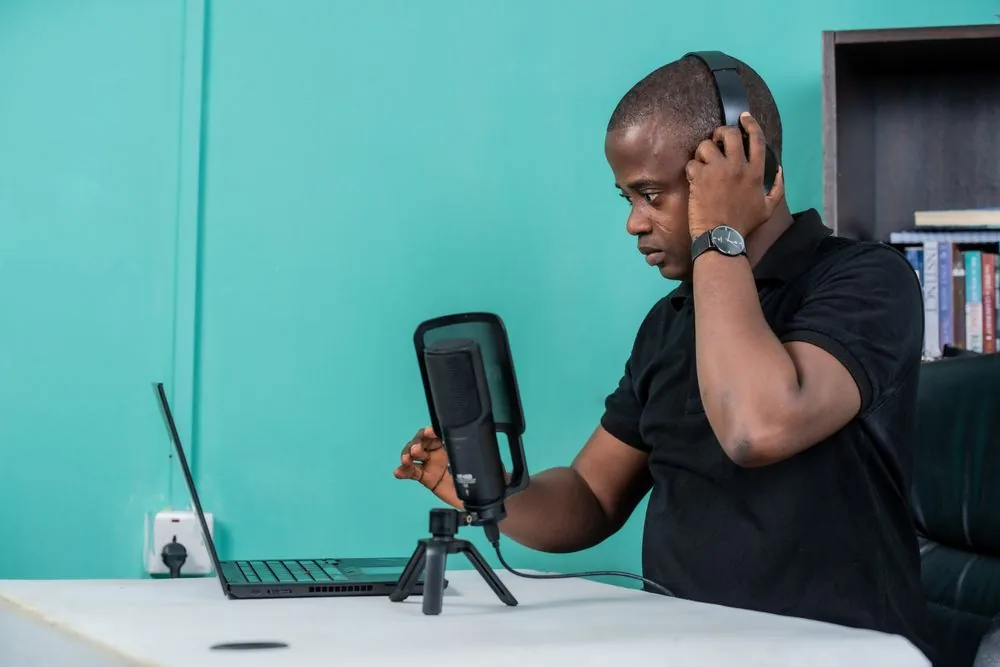 Twitch streamer at a home setup with a microphone and headphones, building a real follower base after buying Twitch followers from BoostPals