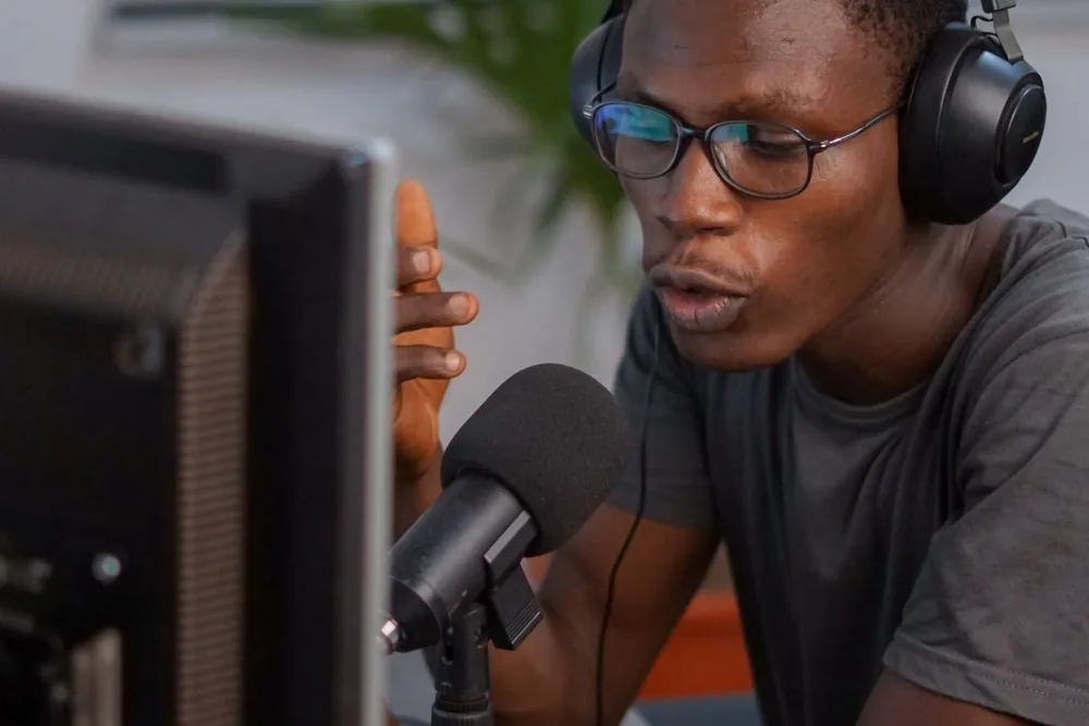 Relaxed, confident streamer at a desk with headphones, representing a safe way to buy Twitch followers with no password required