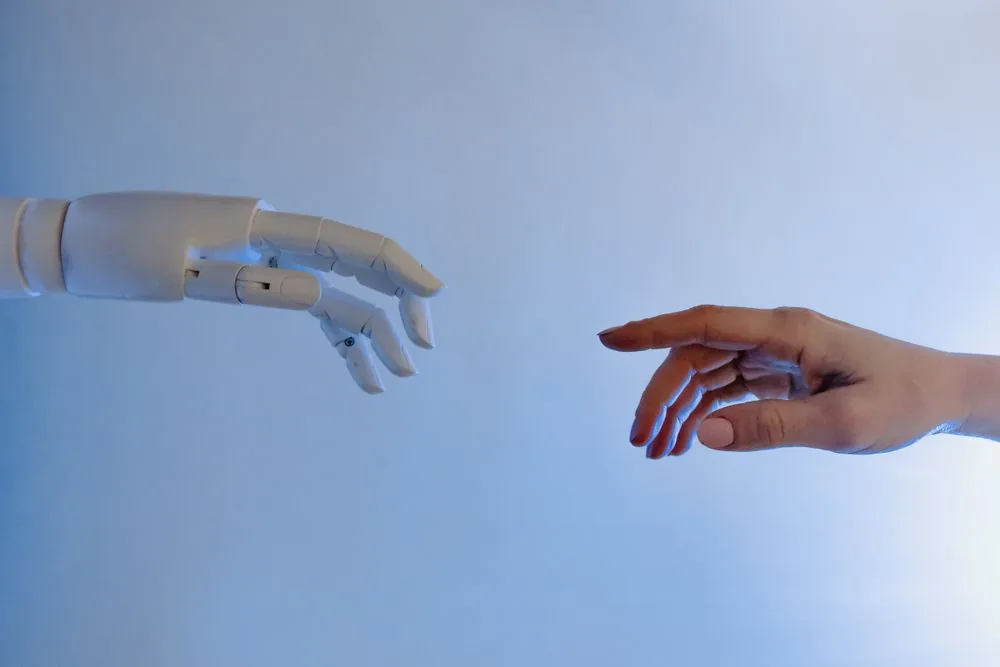 A human hand reaching toward a robot hand, illustrating the difference between high-quality Twitch followers and fake bot accounts that get purged